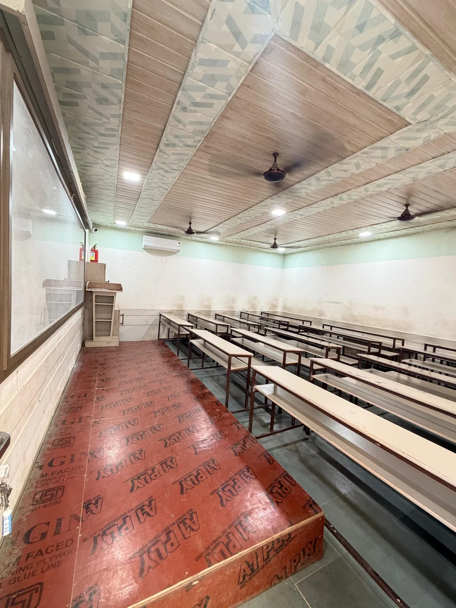 Classroom with benches and teaching platform at Sankalp Tutorials